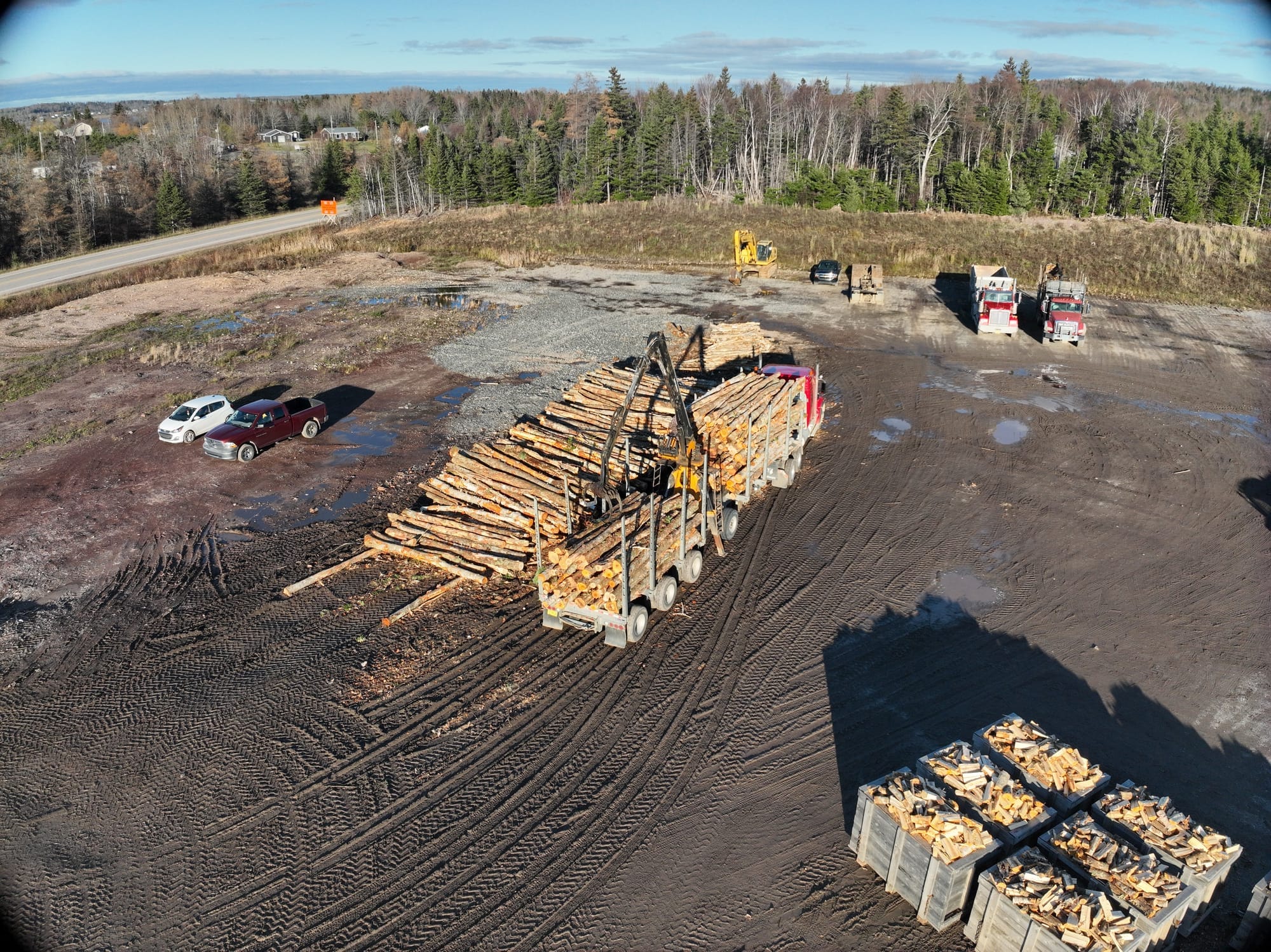 Hugh MacInnis Lumber firewood processing yard with log truck and measurement bins