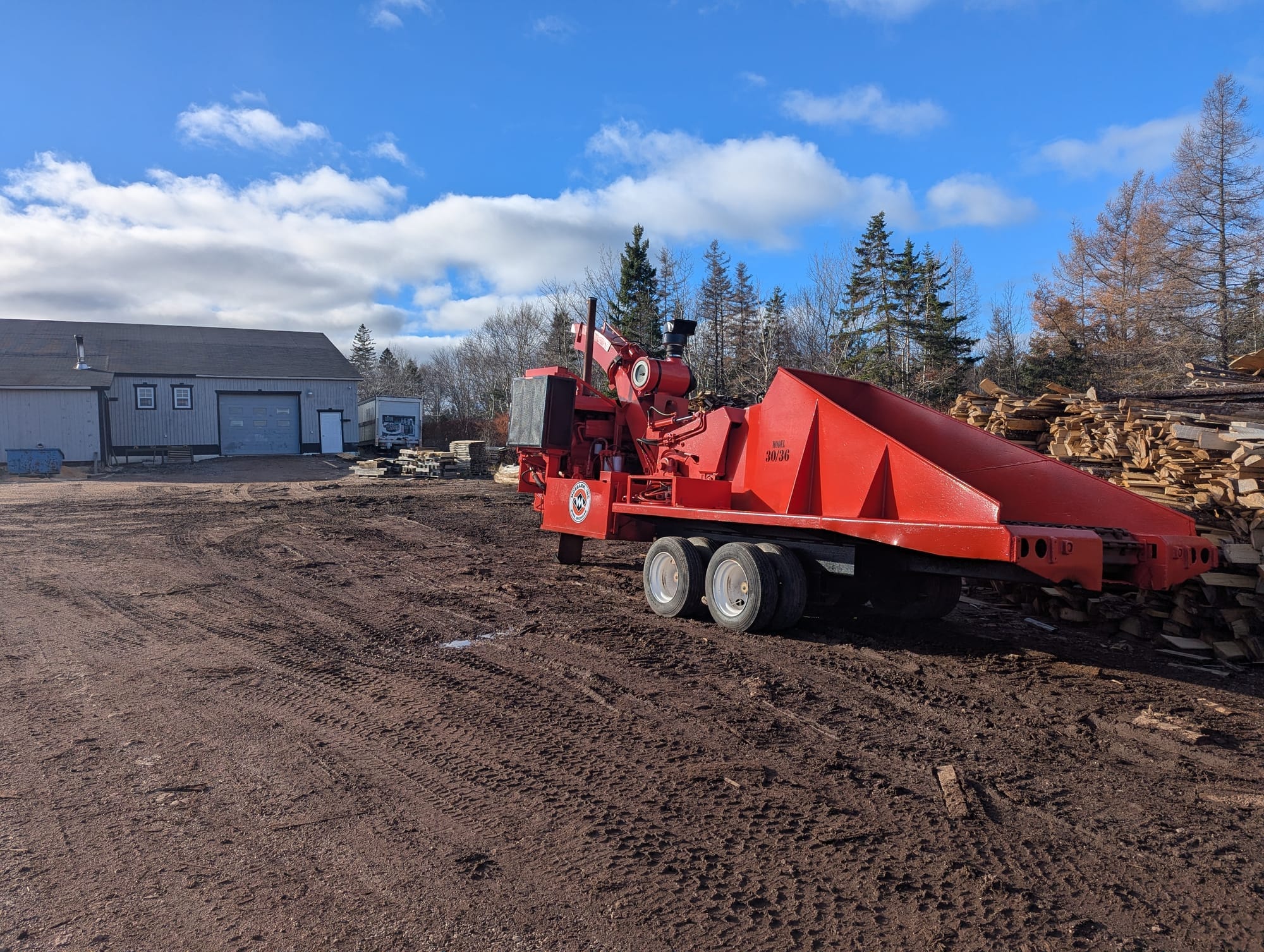 Wood chipper processing sawmill residuals into biomass fuel